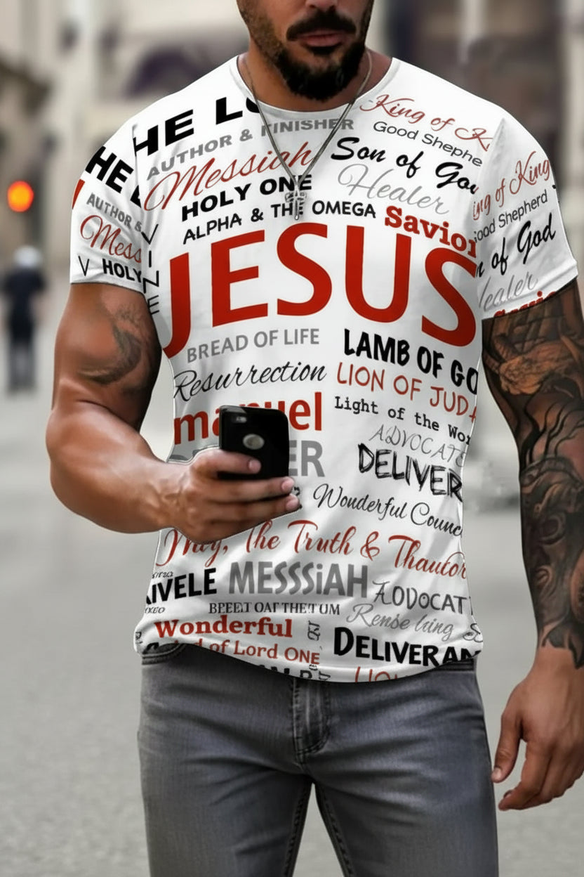 A man wearing a white graphic t-shirt with various religious text and quotes printed in red and black, paired with gray jeans.