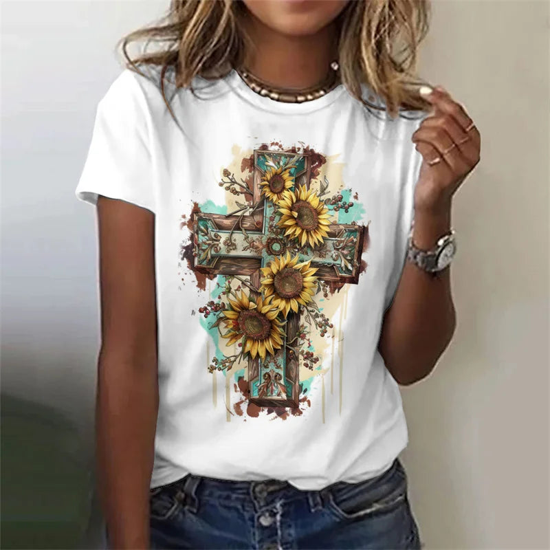 White t-shirt with a cross and sunflower design worn by a person.