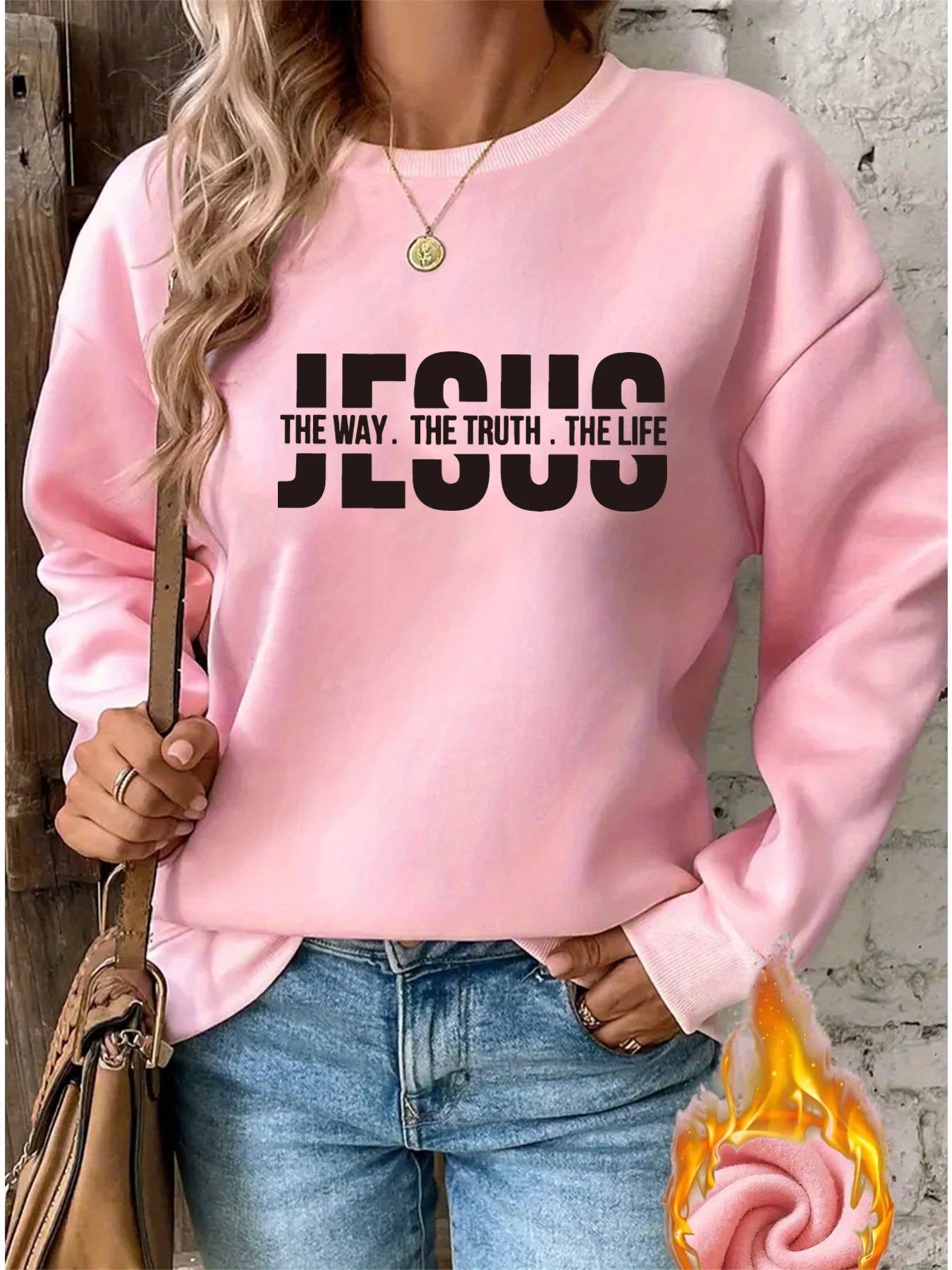 Person wearing a pink sweatshirt with 'JESUS THE WAY. THE TRUTH. THE LIFE' text