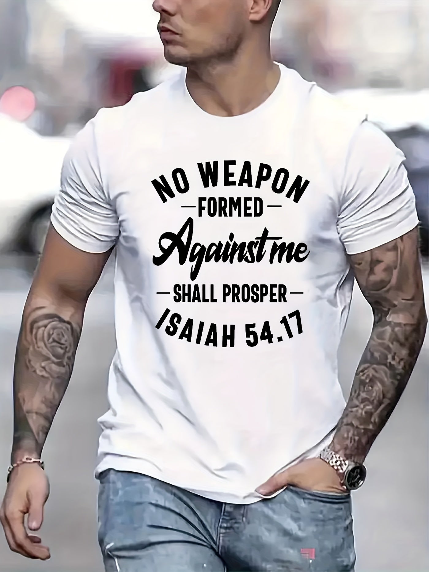 Man wearing a white t-shirt with black text 'No weapon formed against me shall prosper Isaiah 54:17'.