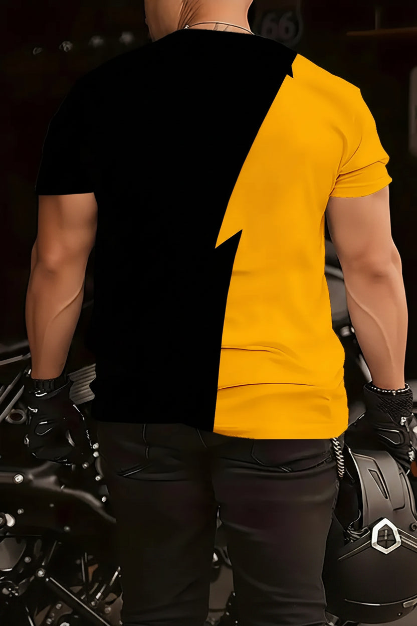 Person wearing a black and yellow shirt with tattoos visible on arms, standing next to a motorcycle.