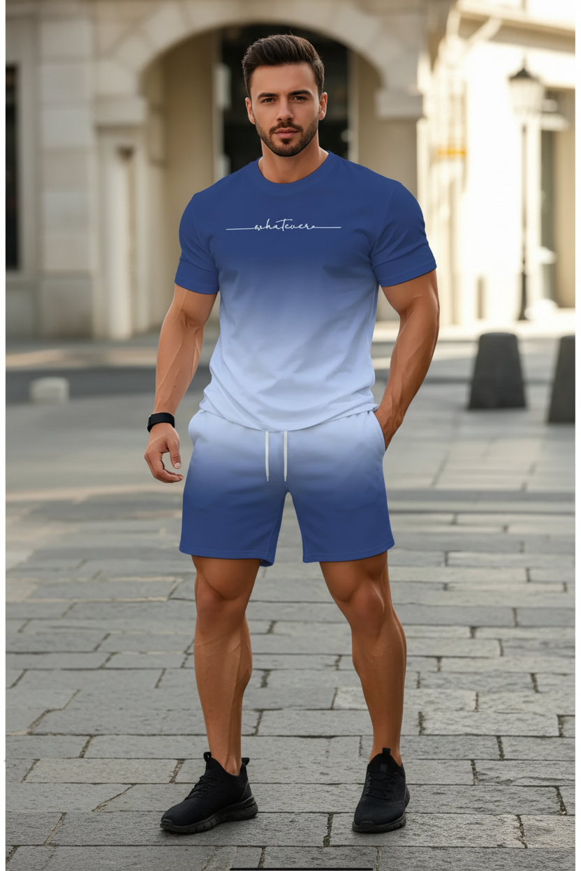 A man wearing a matching blue gradient t-shirt and shorts set with white drawstrings and a white 'whatevers' script on the chest, set against a blurred outdoor background.