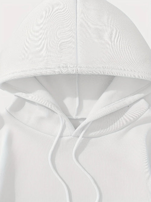 Close-up of a white hooded garment with soft folds on a light gray background