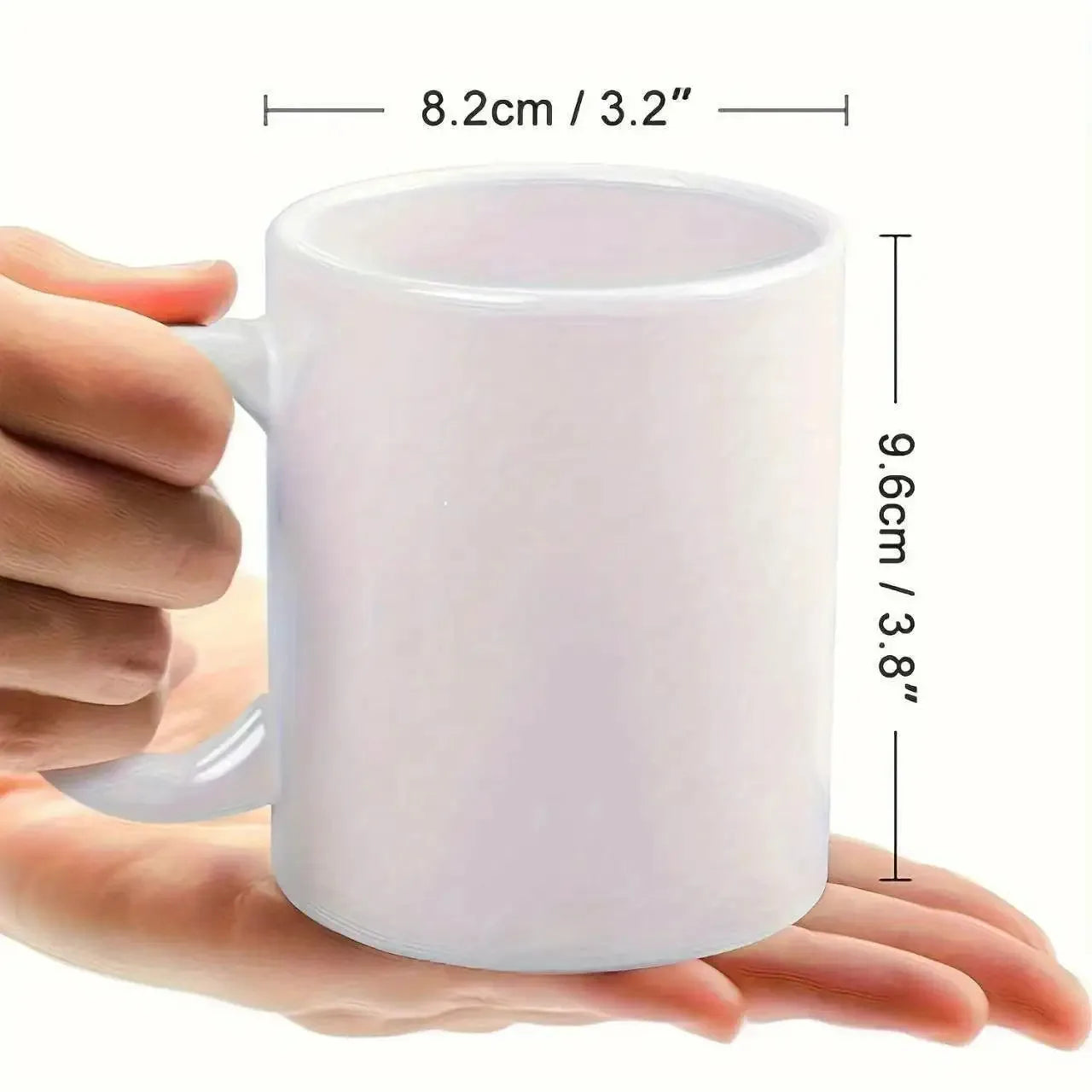 White mug held in a hand with dimensions displayed
