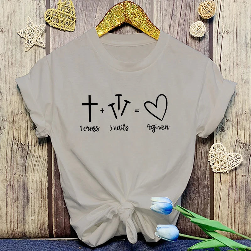 Gray t-shirt with a mathematical equation design on a wooden surface with decorative elements.