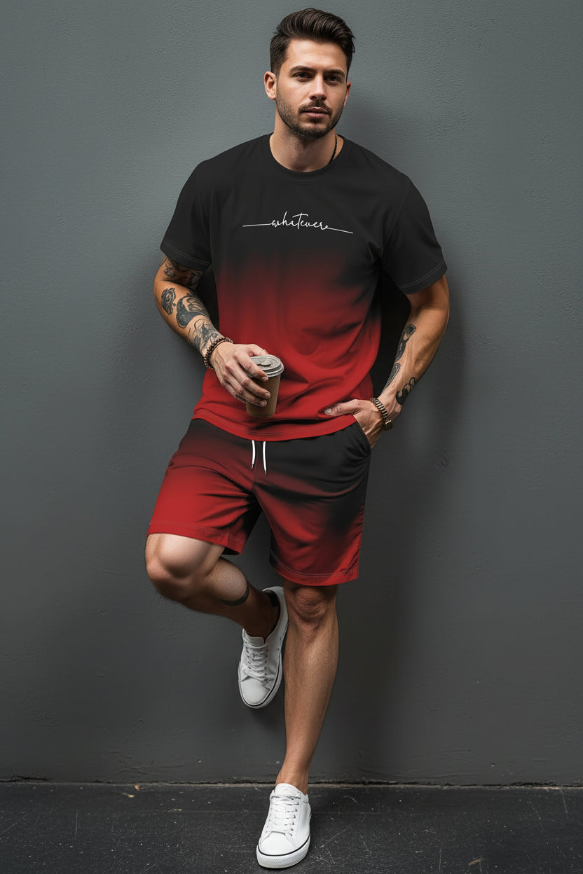 Person wearing a black and red gradient t-shirt with shorts, holding a coffee cup against a gray background.
