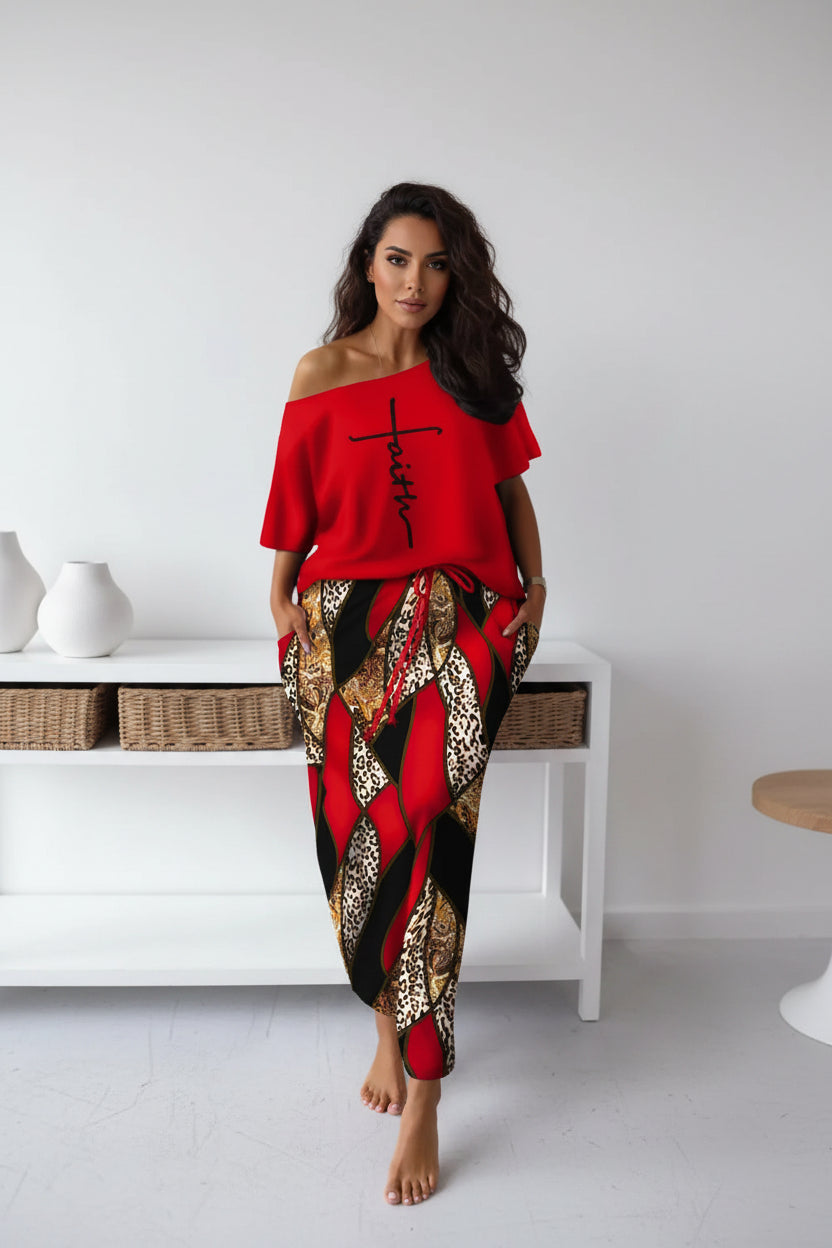 Person wearing a red off-shoulder top with 'Faith' printed on it and patterned pants.
