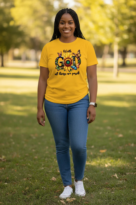 Yellow t-shirt with a sunflower and butterfly design and text 'With God all things are possible'.