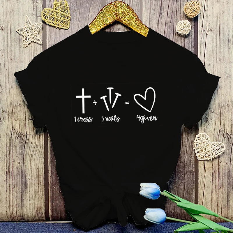 Black t-shirt with a mathematical equation design on a wooden surface with decorative elements.