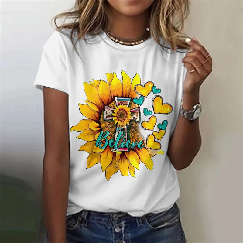 White t-shirt with a sunflower and heart design on a plain background