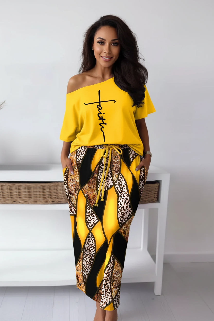 Person wearing a yellow off-shoulder top with 'Faith' printed on it and patterned pants.