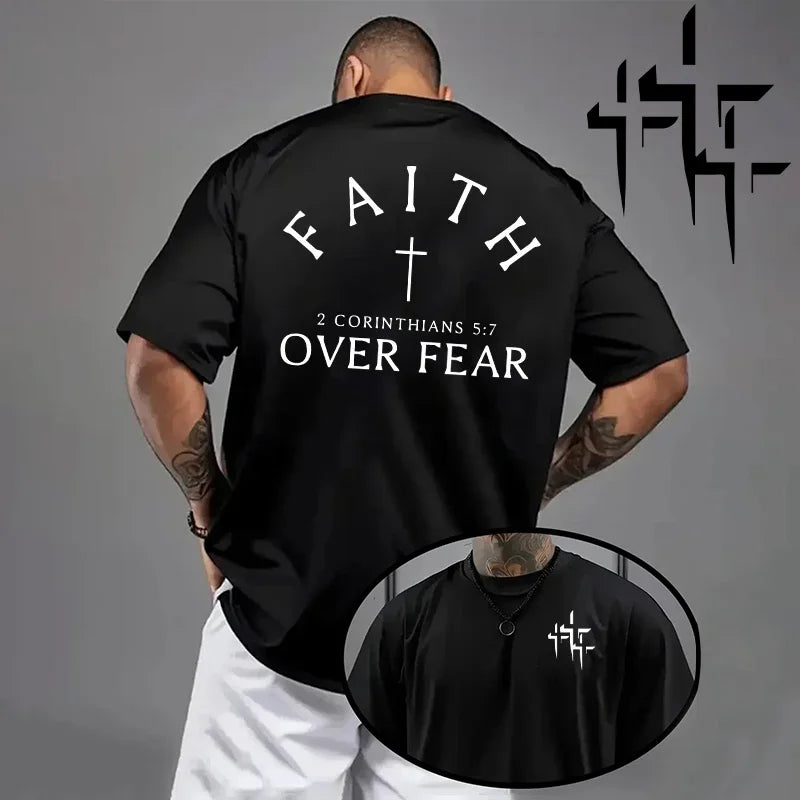 Black t-shirt with 'Faith Over Fear' text and cross on the back, worn by a person, with a logo on the gray background.