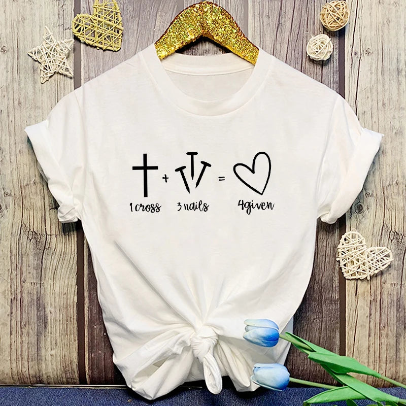 White t-shirt with a mathematical equation design on a wooden surface with decorative elements.