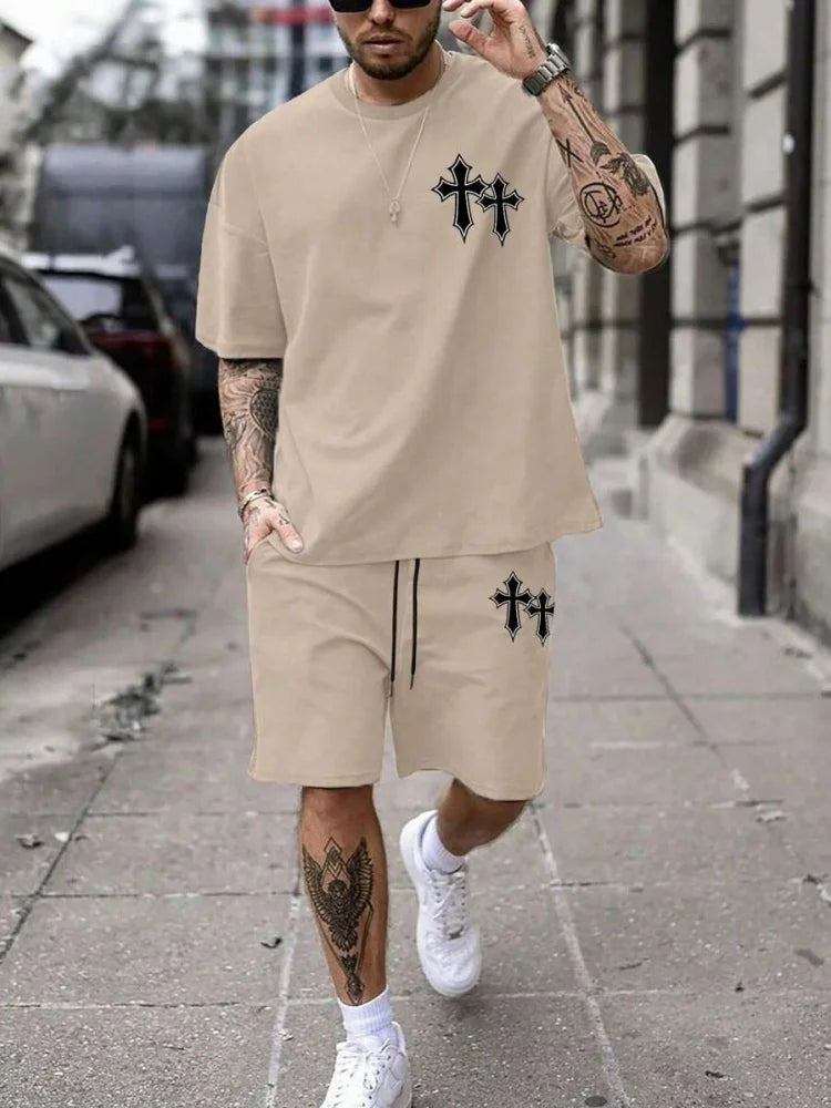 Man wearing a beige outfit with black cross designs on a city street.