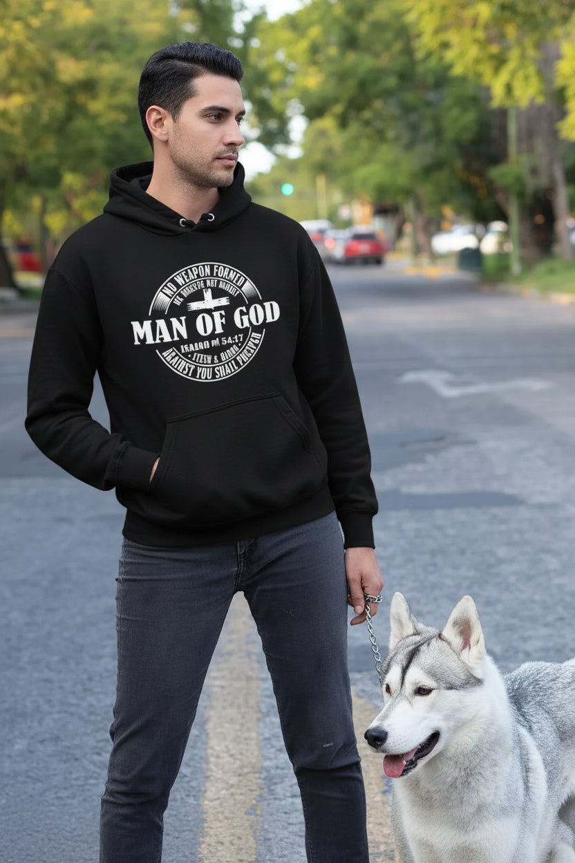 Man wearing a black hoodie with 'Man of God' text, standing on a street with a dog.