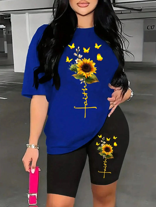 Woman wearing a blue t-shirt and black long shorts with sunflower and butterfly design