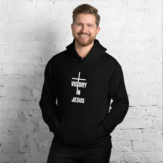 Man wearing a black hoodie with 'Victory in Jesus' text 
